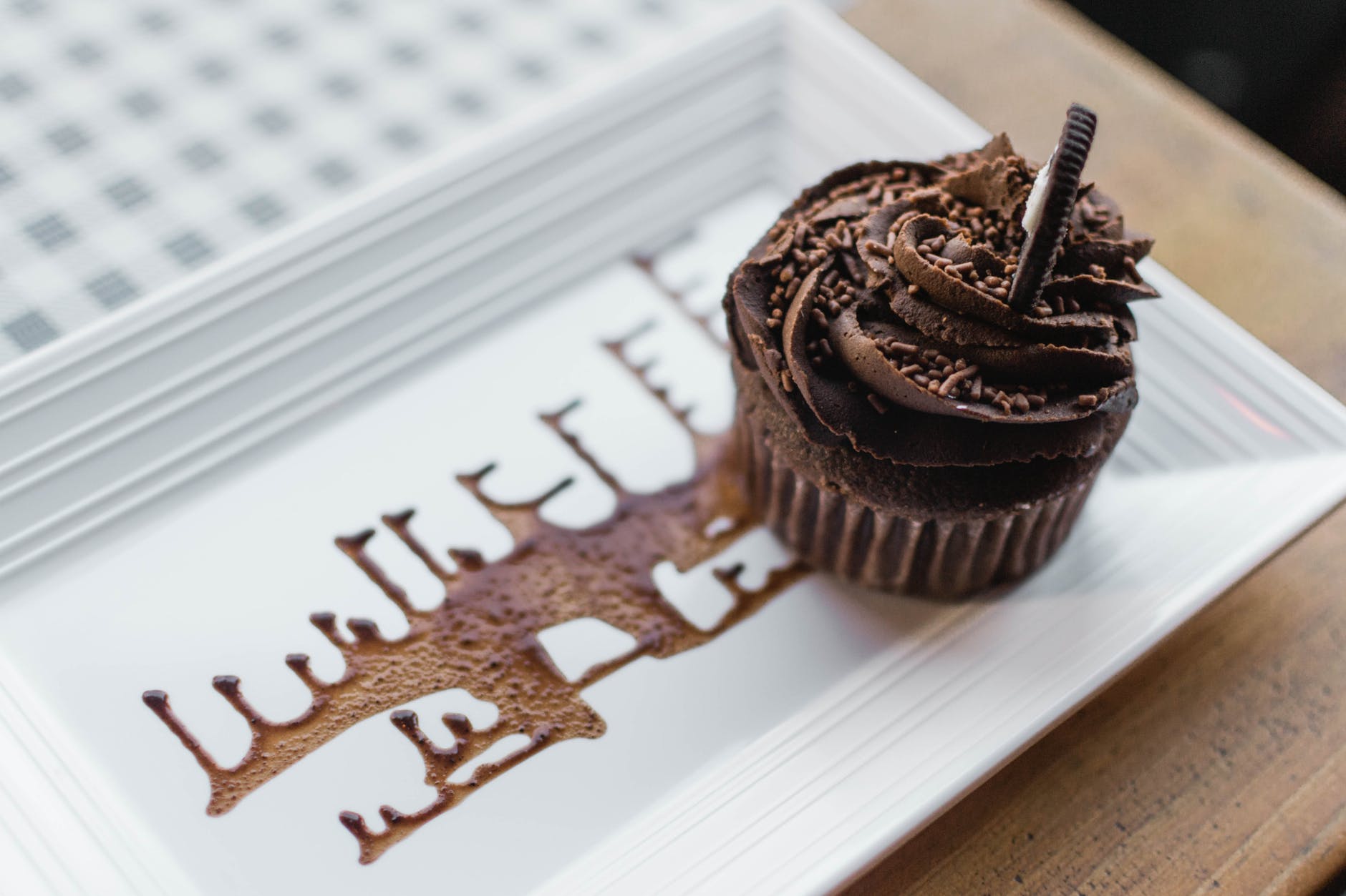 close up photo of chocolate cupcake on a rectangular plate